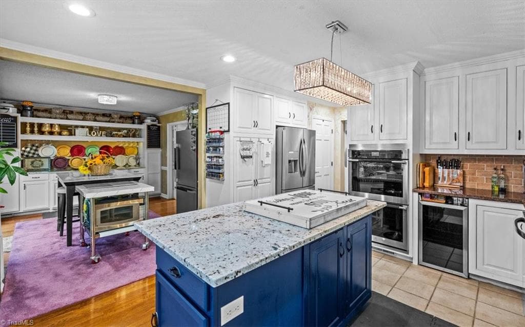 There's prep space galore with appliances to support several occupants or dozens of guests. A wine cabinet, double ovens, dishwasher, and numerous cabinets for storage. - 6352 Turnpike Road, High Point NC 27263, High Point