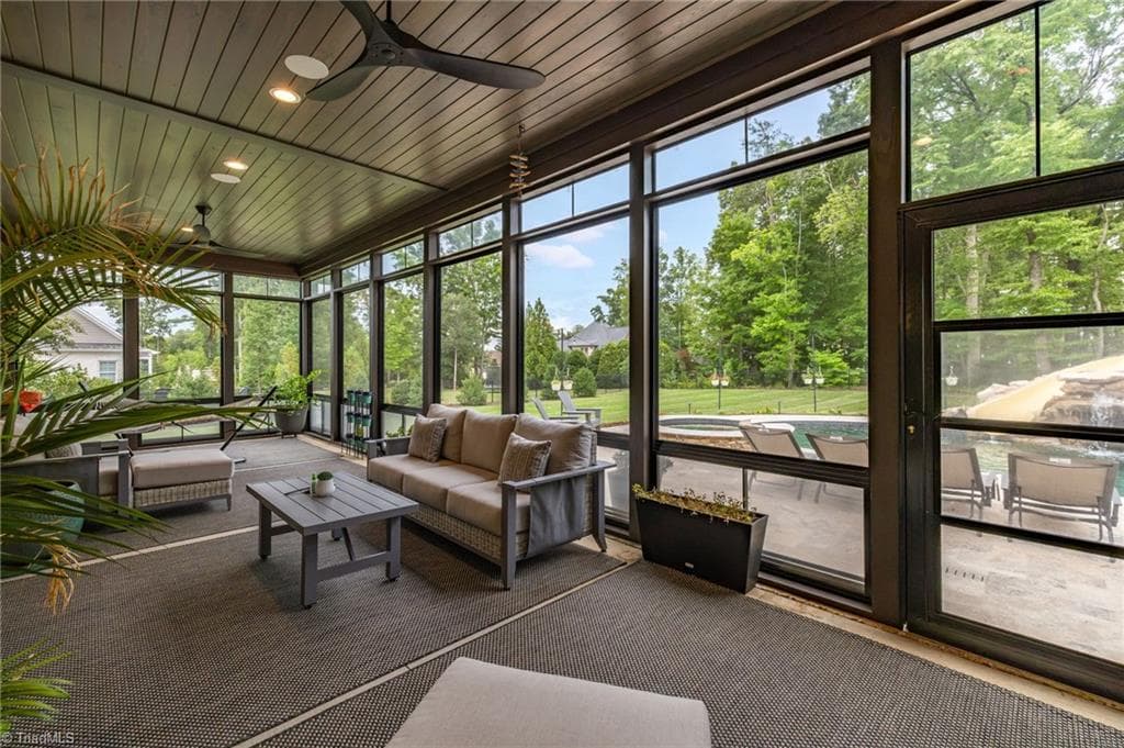 Relaxing screened porch with EZ Vue windows overlooks the pool and backyard activities! - 5503 Briardenn Court, Summerfield NC 27358, Summerfield