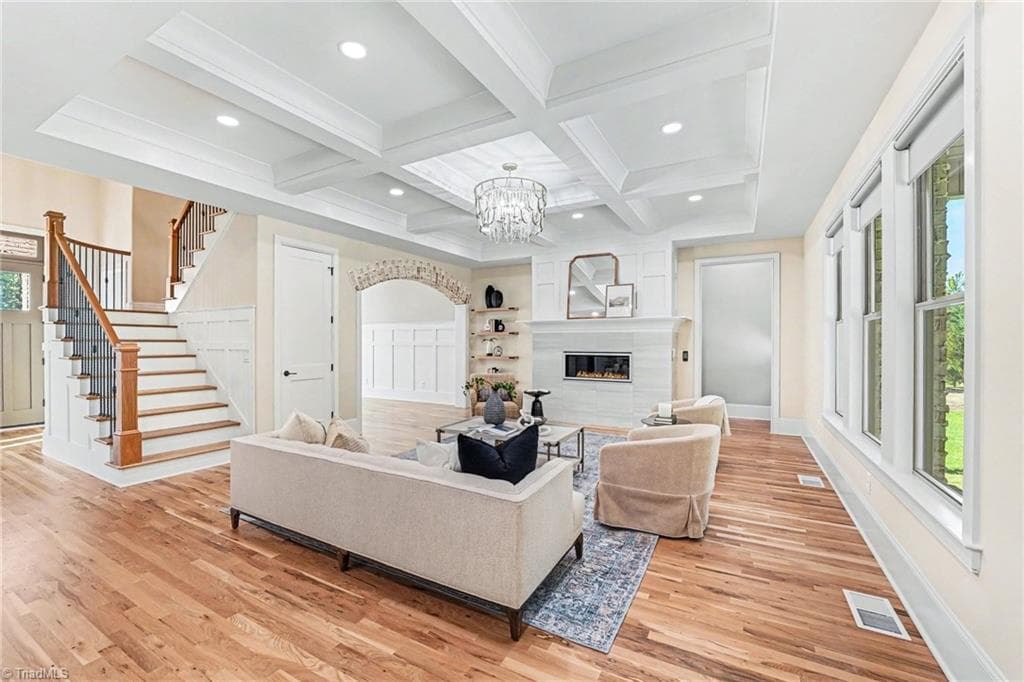 This versatile main-level flex room offers a perfect space for an additional living area, a quiet reading retreat, or a private home office. The room is beautifully appointed with intricate trimwork and a unique curved wall design. - 1477 Cappoquin Way, Burlington NC 27215, Burlington