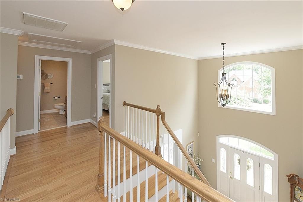 Hardwood flooring throughout the upper-level landing, featuring abundant natural light and direct access to the third and fourth bedrooms. - 1101 Clyde Edgerton Drive, Kernersville NC 27284, Kernersville