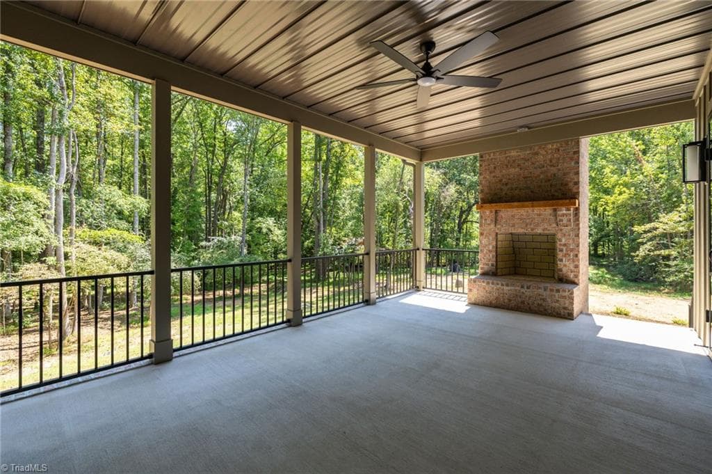 Spacious covered back porch with wood fireplace. - 568 N Bunker Hill Road, Oak Ridge NC 27310, Oak Ridge