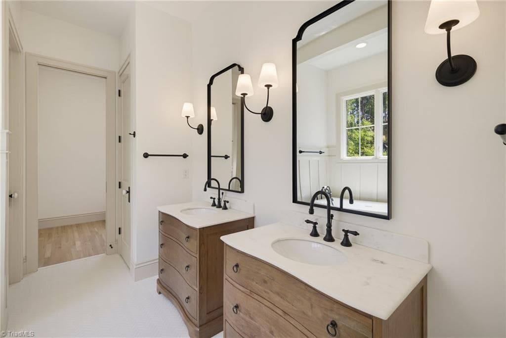 Primary bathroom with dual vanities. - 568 N Bunker Hill Road, Oak Ridge NC 27310, Oak Ridge