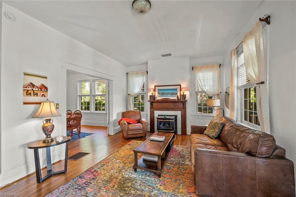 The living room is flooded  with light and opens directly into the adjacent dining room. - 1023 N Main Street, Mount Airy NC 27030, Mount Airy