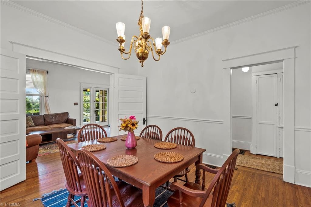 The dining room works for both formal and casual entertaining.  Take a look at those large original double doors leading into the living room! - 1023 N Main Street, Mount Airy NC 27030, Mount Airy
