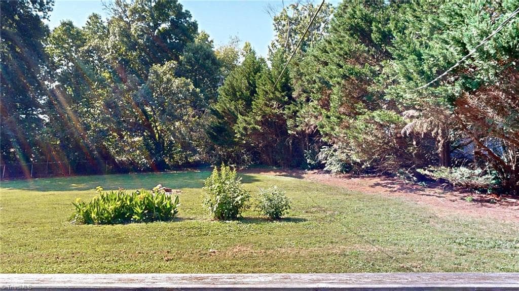 Looking from the patio to the back yard, level and so private. - 1804 Ramsey Road, Kernersville NC 27284, Kernersville