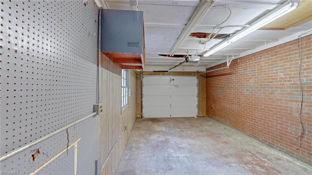 Another view of the Garage, pegboard for your tool and a shelf, the Auto Door Opener does NOT work - 1804 Ramsey Road, Kernersville NC 27284, Kernersville