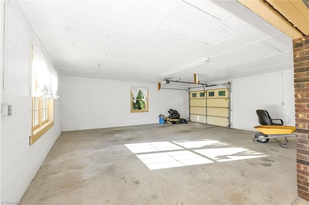 Garage off the 2nd large room in the basement, looking from the garage door area of the room (the original garage before this garage was added. - 196 Lewis Fork Drive, Wilkesboro NC 28697, Wilkesboro