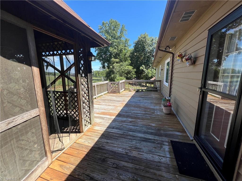 Looking from screened Gazebo down the length of the large deck. - 196 Lewis Fork Drive, Wilkesboro NC 28697, Wilkesboro