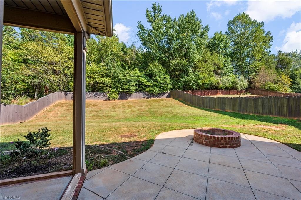 Fire pit patio, wooded backdrop - 1249 Meadow Chase Drive, Lewisville NC 27023, Lewisville