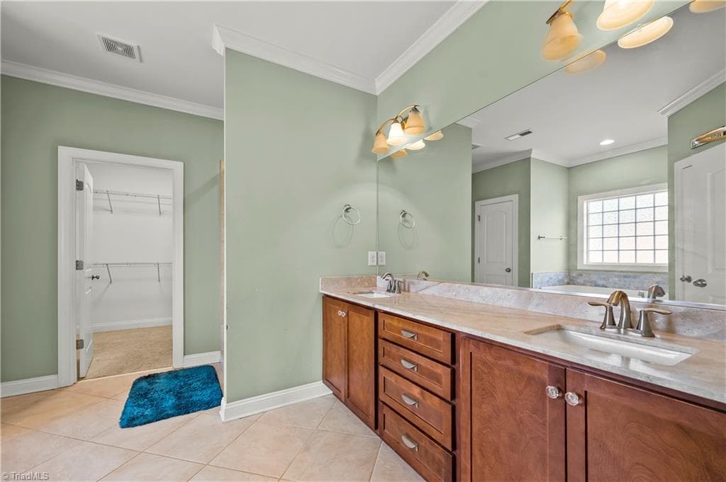 Primary bathroom, Dual vanities, walk-in closet - 1249 Meadow Chase Drive, Lewisville NC 27023, Lewisville