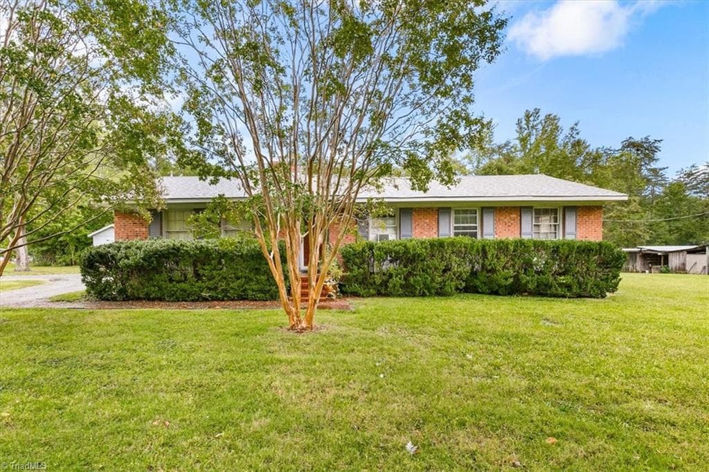 Front of the home with mature crape myrtles and established shrubs. - 5822 RuralView Road, Gibsonville NC 27249, Gibsonville