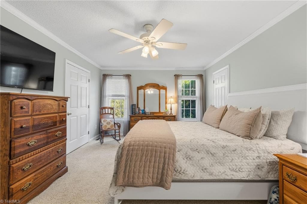 Notice the two doors behind the bed.  This primary suite boasts two closets! - 7405 Cortney Glen Lane, Lewisville NC 27023, Lewisville