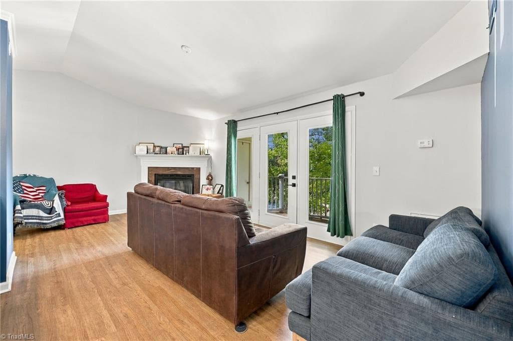 Living room with big glass doors that leads to the veranda of the unit. - 5928 W Friendly Avenue # M, Greensboro NC 27410, Greensboro