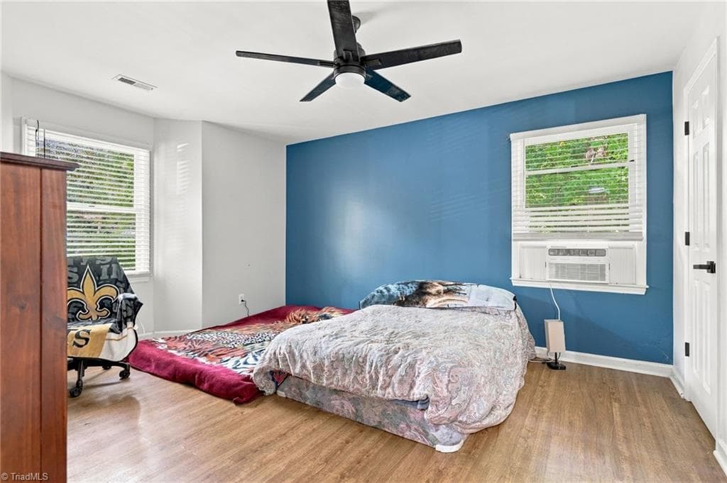 Primary bedroom with ceiling fan and ample closet space. - 5928 W Friendly Avenue # M, Greensboro NC 27410, Greensboro