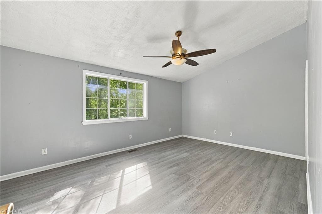 Huge primary bedroom with ceiling fan on the second floor area of the home. - 5500 Richland Street # A, Greensboro NC 27409, Greensboro