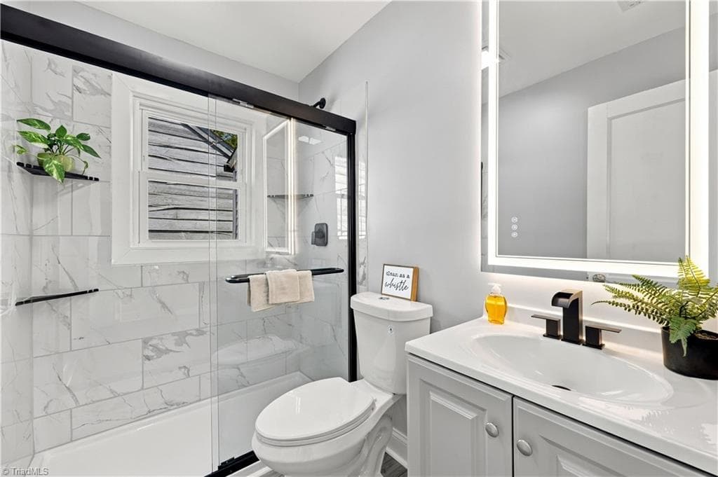 Beautifully renovated bathroom with dimmable mirror. - 1113 Benjamin Benson Street, Greensboro NC 27406, Greensboro