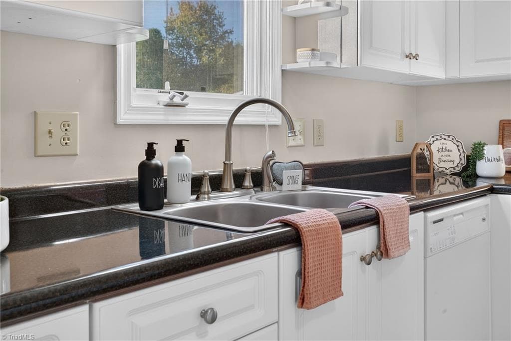 A closer look at the kitchen workspace, with generous counters and a window bringing in natural light. - 4407 Cove Cay Lane, Greensboro NC 27410, Greensboro