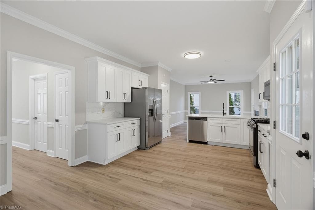 Renovated kitchen with timeless white cabinetry, Quartz countertops and stainless appliances. - 2100 Gate Post Drive, Greensboro NC 27455, Greensboro
