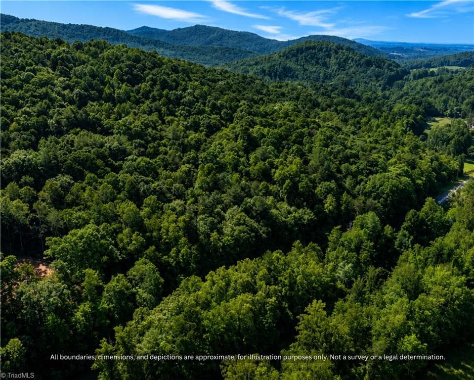 Aerial of the wooded ridge on this land, with mountain views - 99999 Boone Gap Lane, Taylorsville NC 28681, Taylorsville
