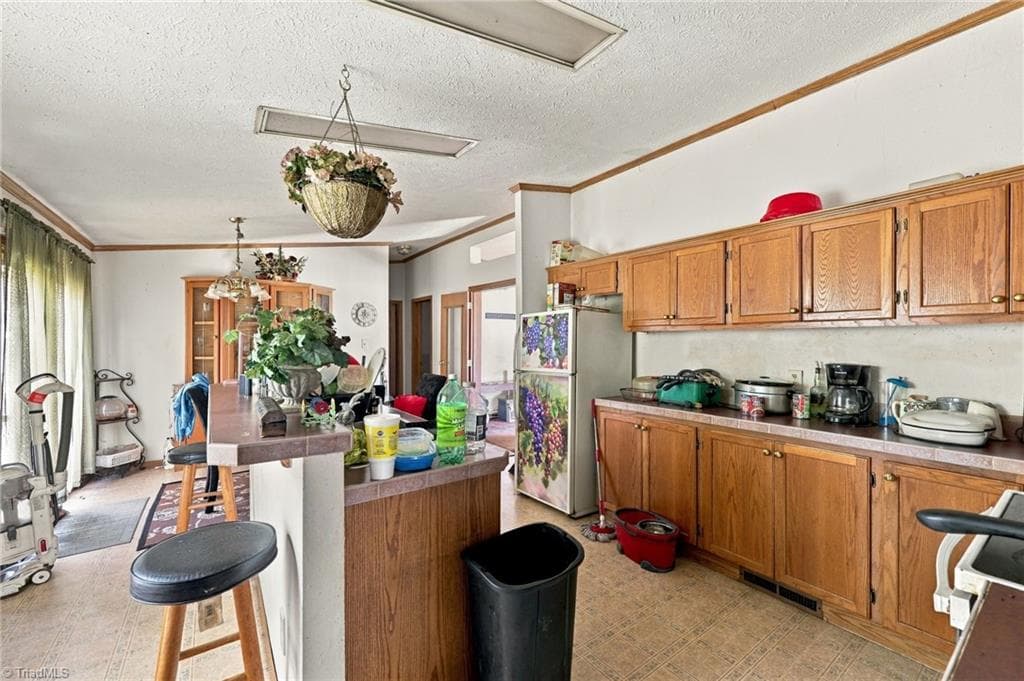 Kitchen with island and bar seating. - 415 Talley Road, Reidsville NC 27320, Reidsville