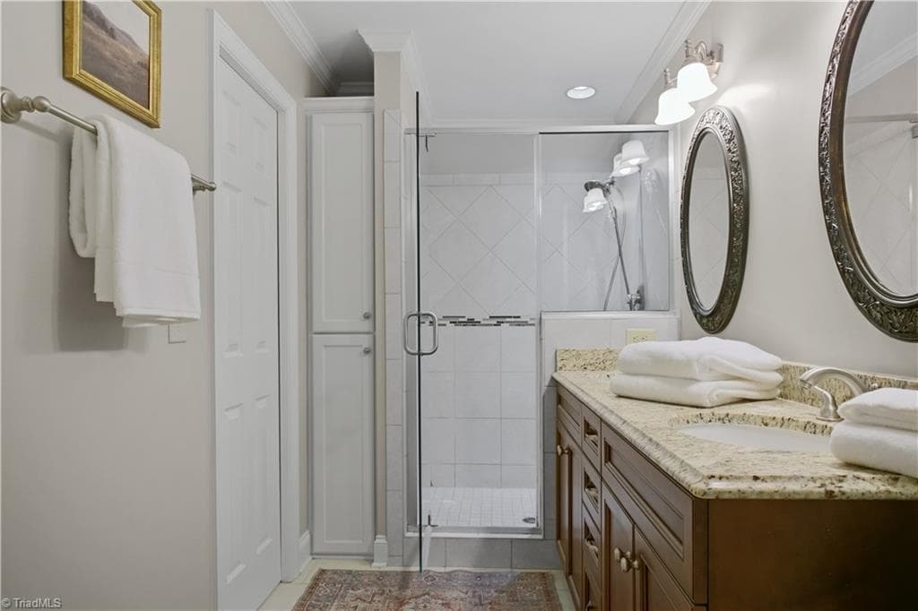 Primary bathroom with double vanities and walk-in shower. - 1206 Hill Street, Greensboro NC 27408, Greensboro