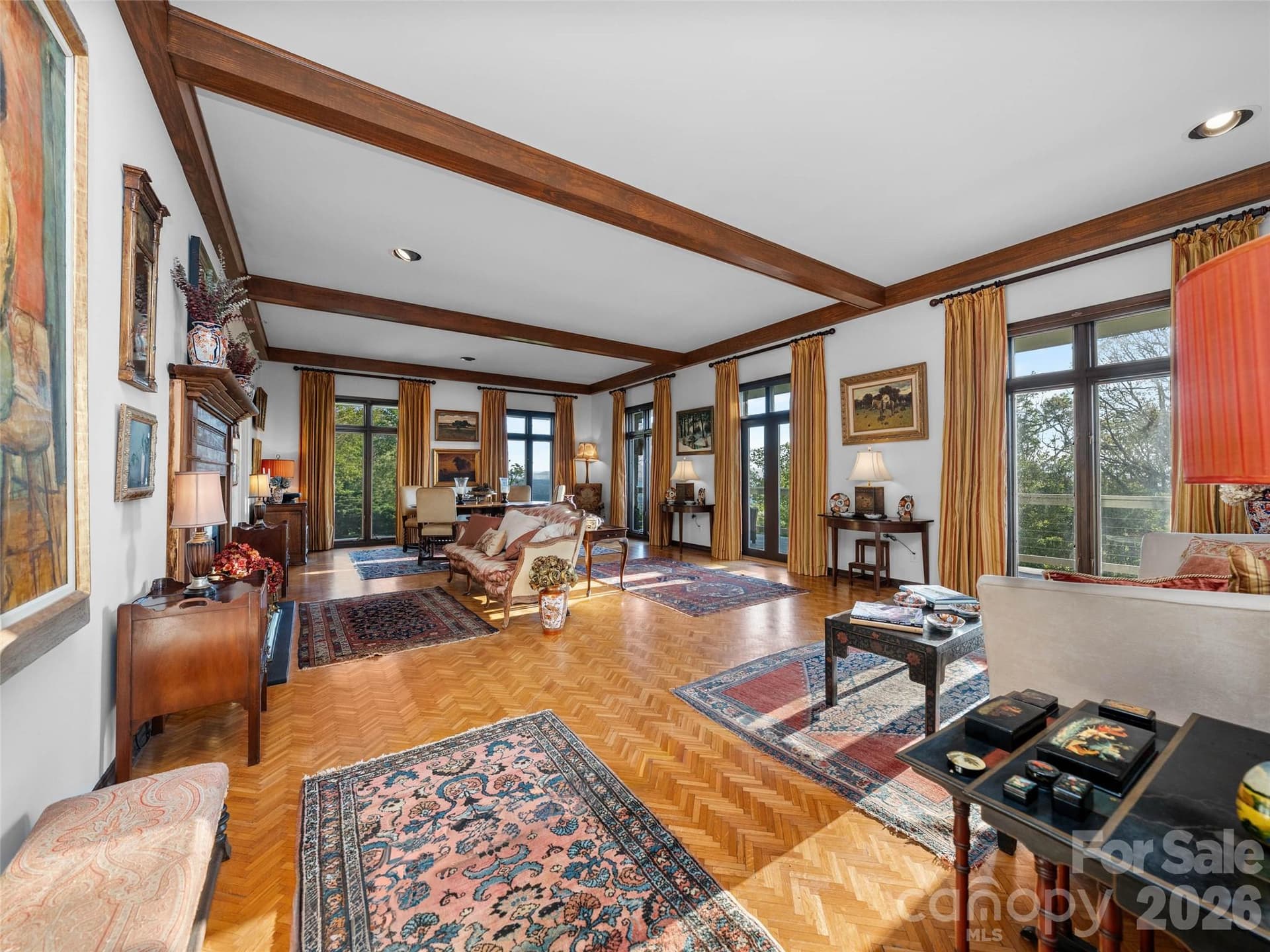 A gracious gathering space centered around a wood-burning fireplace, beautiful artwork, and elegant mountain living. - 65 Crestwood Road, Asheville