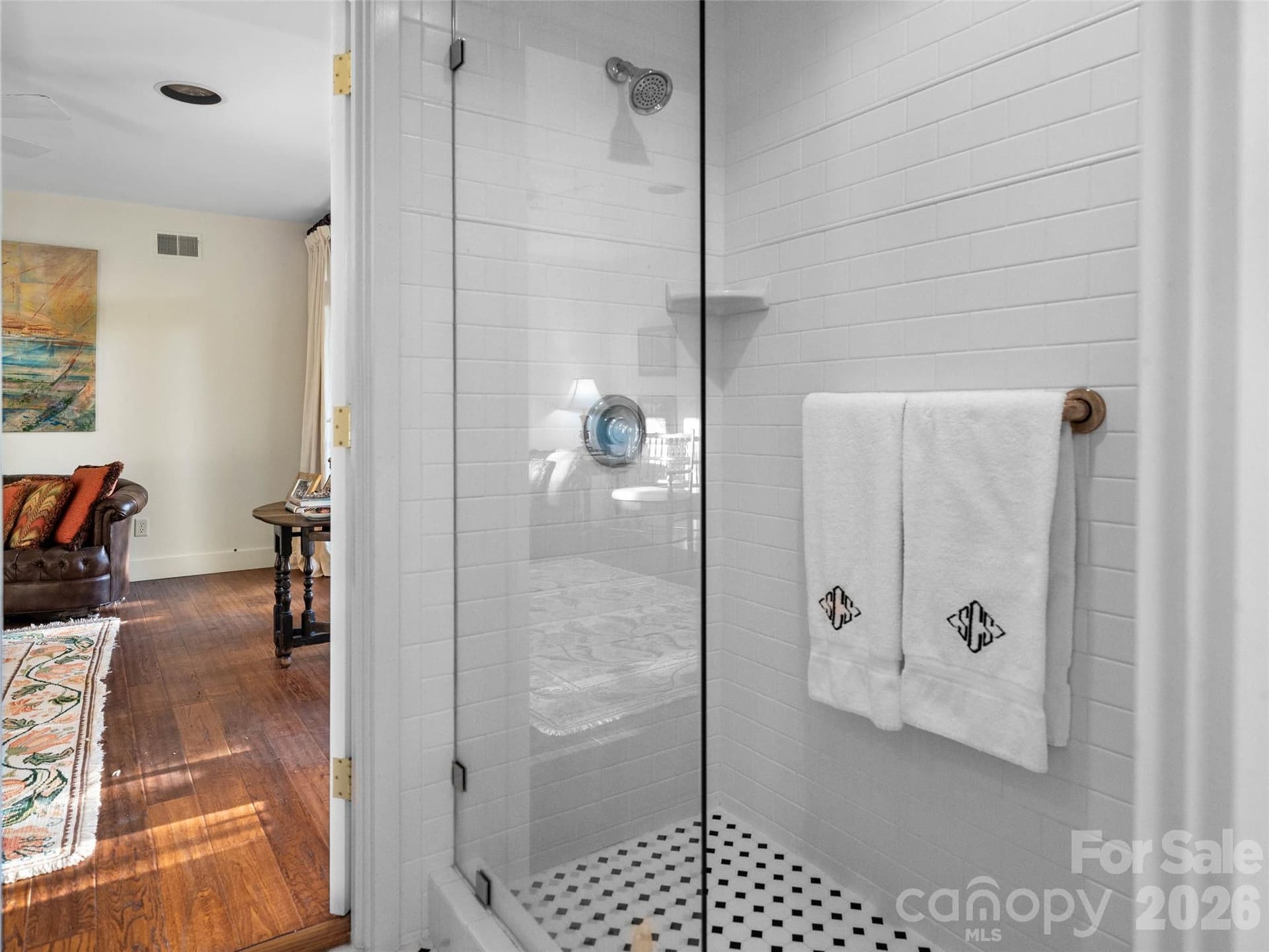 A timeless white bathroom with a spacious shower and convenient access to both the bedroom and adjoining den. - 65 Crestwood Road, Asheville