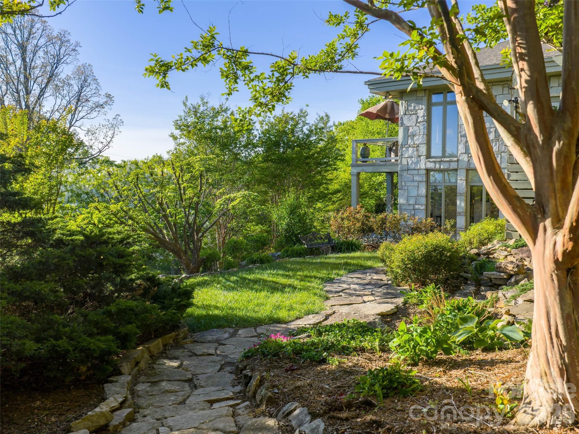 Gardens and winding paths surround the home with beauty in every season. - 65 Crestwood Road, Asheville