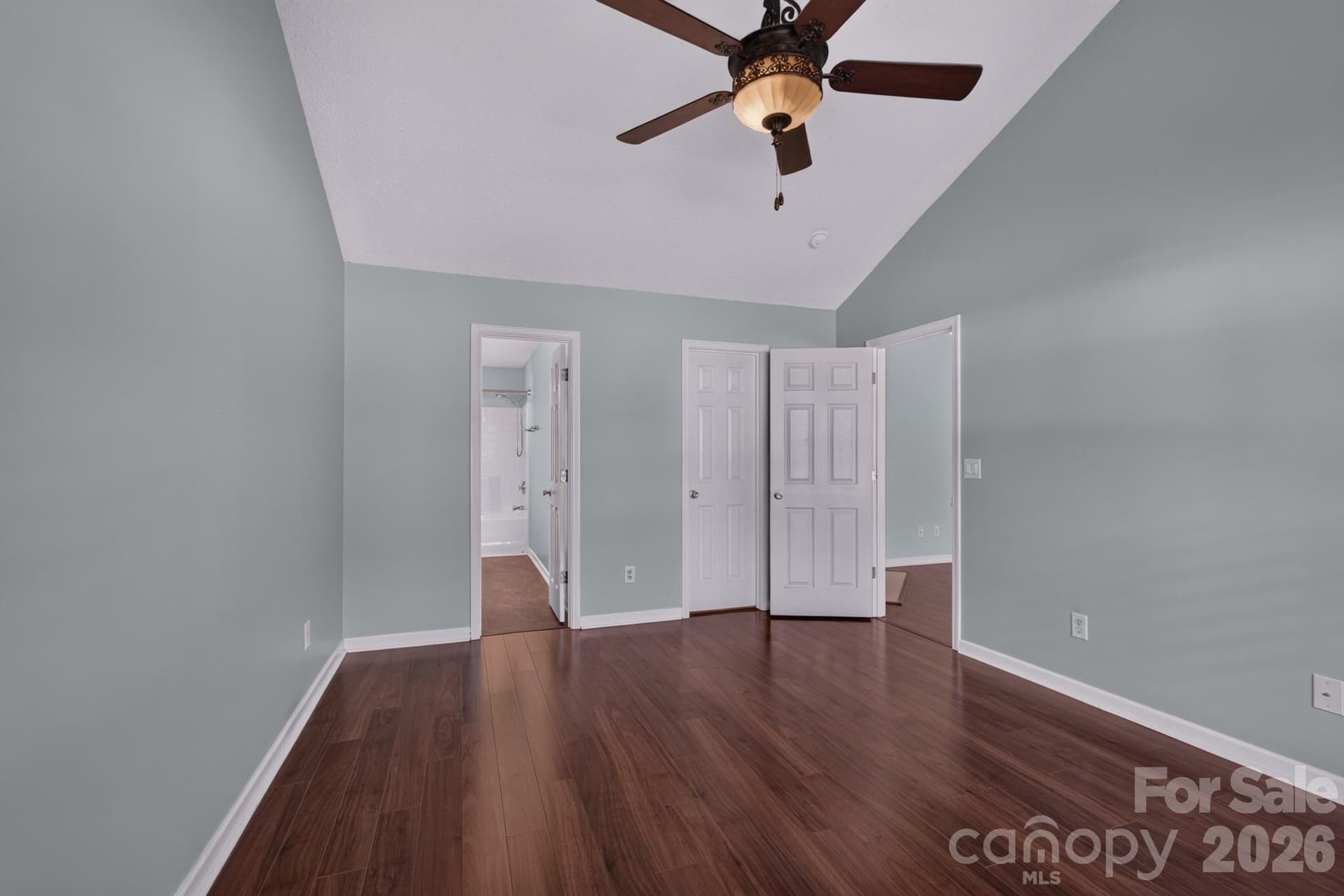 Peaceful primary retreat featuring hardwood floors, ceiling fan, and lovely window views. - 702 Painted Lady Court, Rock Hill