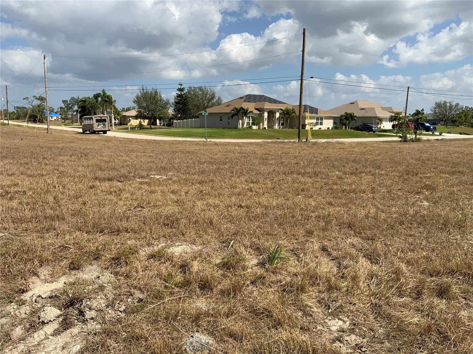 View of Established Neighborhood Across the Street - 2113 NE 43RD LN, CAPE CORAL