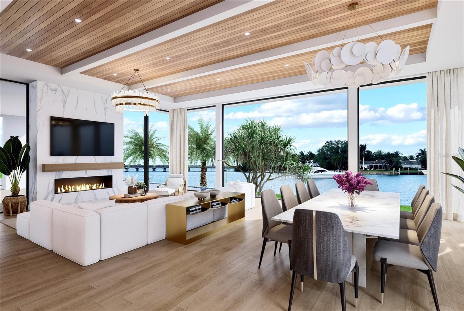 The open concept design emphasizes natural light and a seamless indoor-outdoor connection. The electric fireplace adds a cozy element. The 11 foot  floor-to-ceiling glass windows provide an expansive view The Sarasota Yacht Club and Sarasota Bay. - 109 N WARBLER LN, SARASOTA