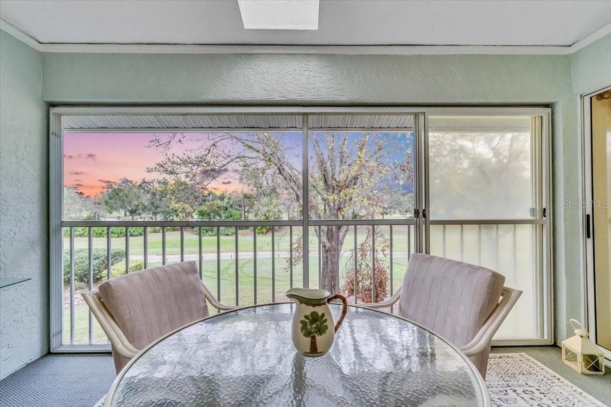 lanai looking out to golf course - 6713 STONE RIVER RD #206, BRADENTON