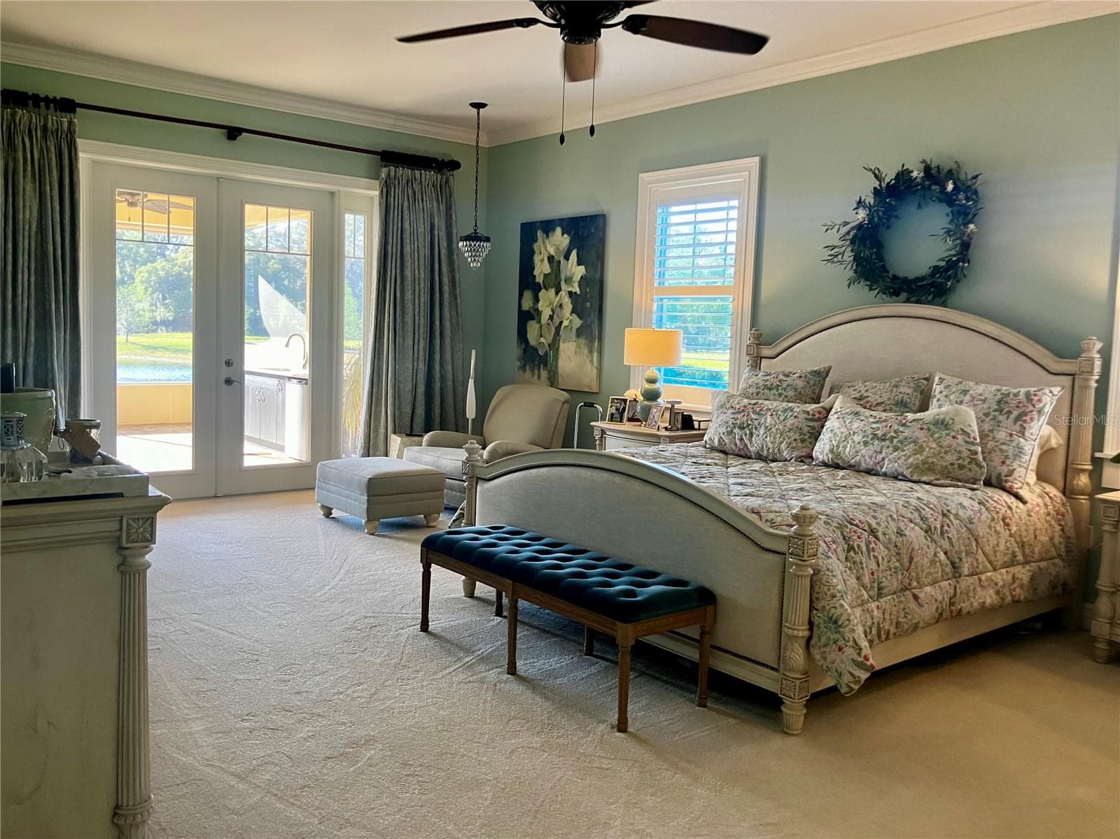 Primary bedroom with french doors to enclosed porch and pond view - 3709 GALLAGHER RD, PLANT CITY