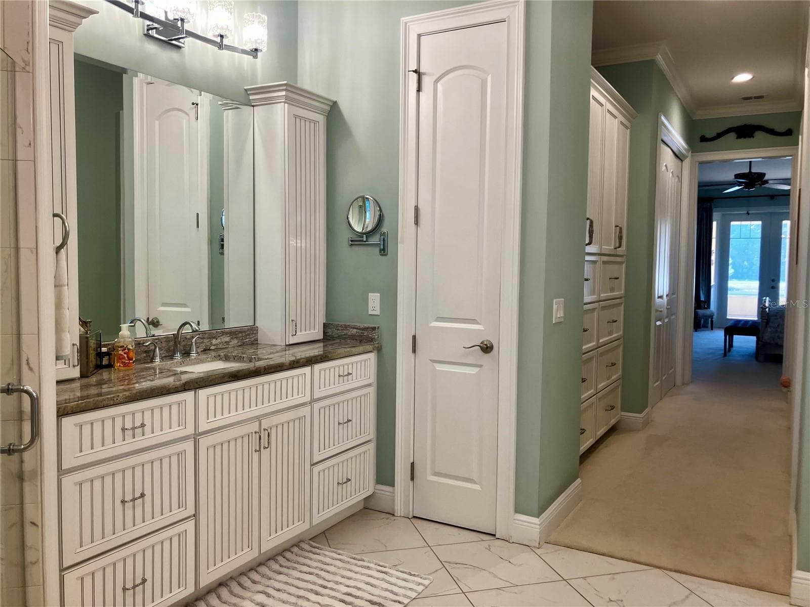 En-suite bath has separate vanity sinks with granite counters, connected to closet area with built in cabinets and separate closets. - 3709 GALLAGHER RD, PLANT CITY