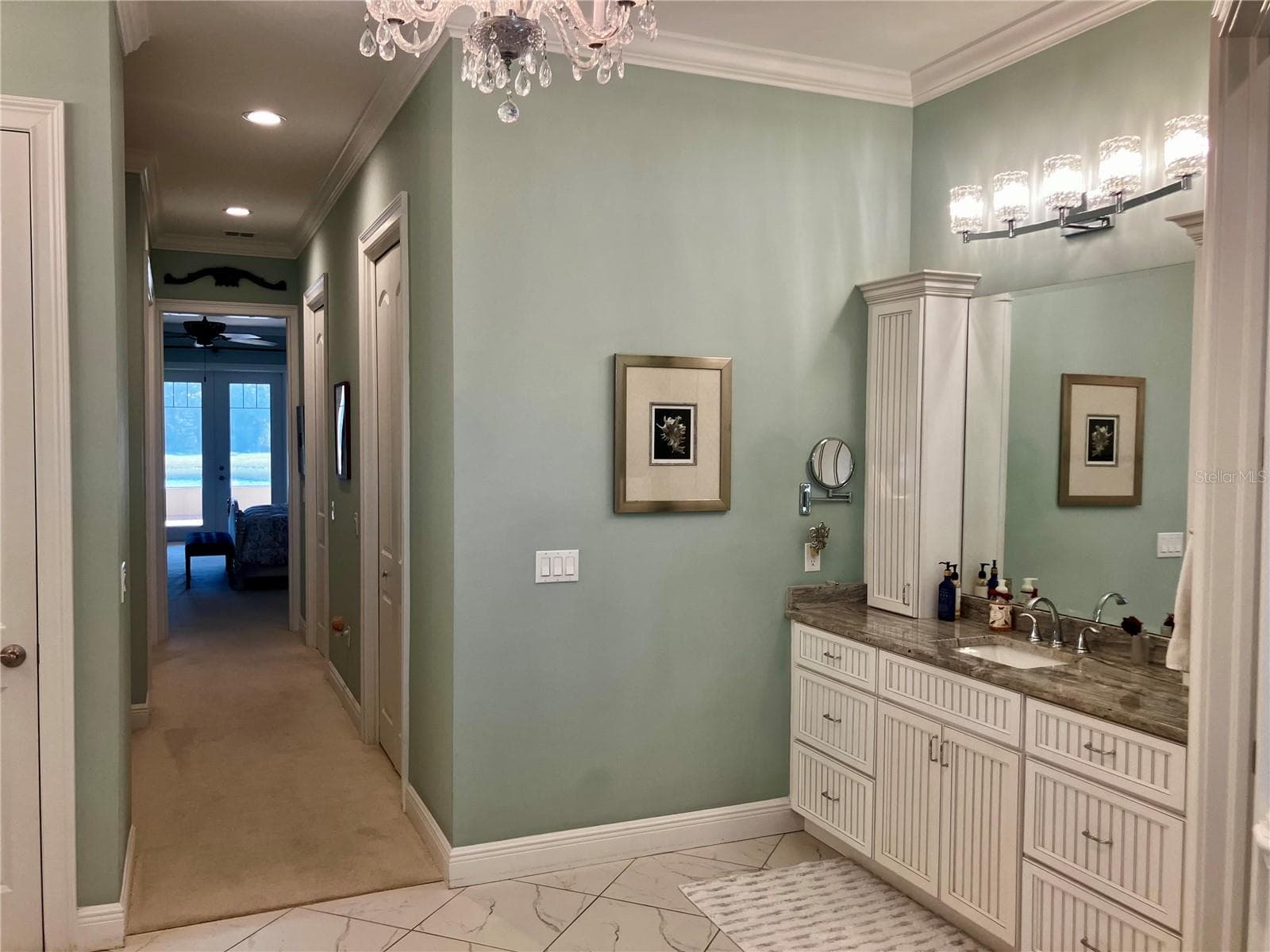 En suite bath has separate vanity sinks with granite counters, connected to closet area with built in cabinets and separate closets. - 3709 GALLAGHER RD, PLANT CITY