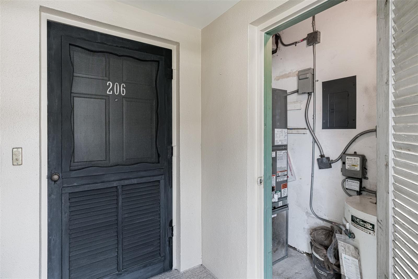 Front entrance with utility closet - 147 BLUFF VIEW DR #206, BELLEAIR BLUFFS