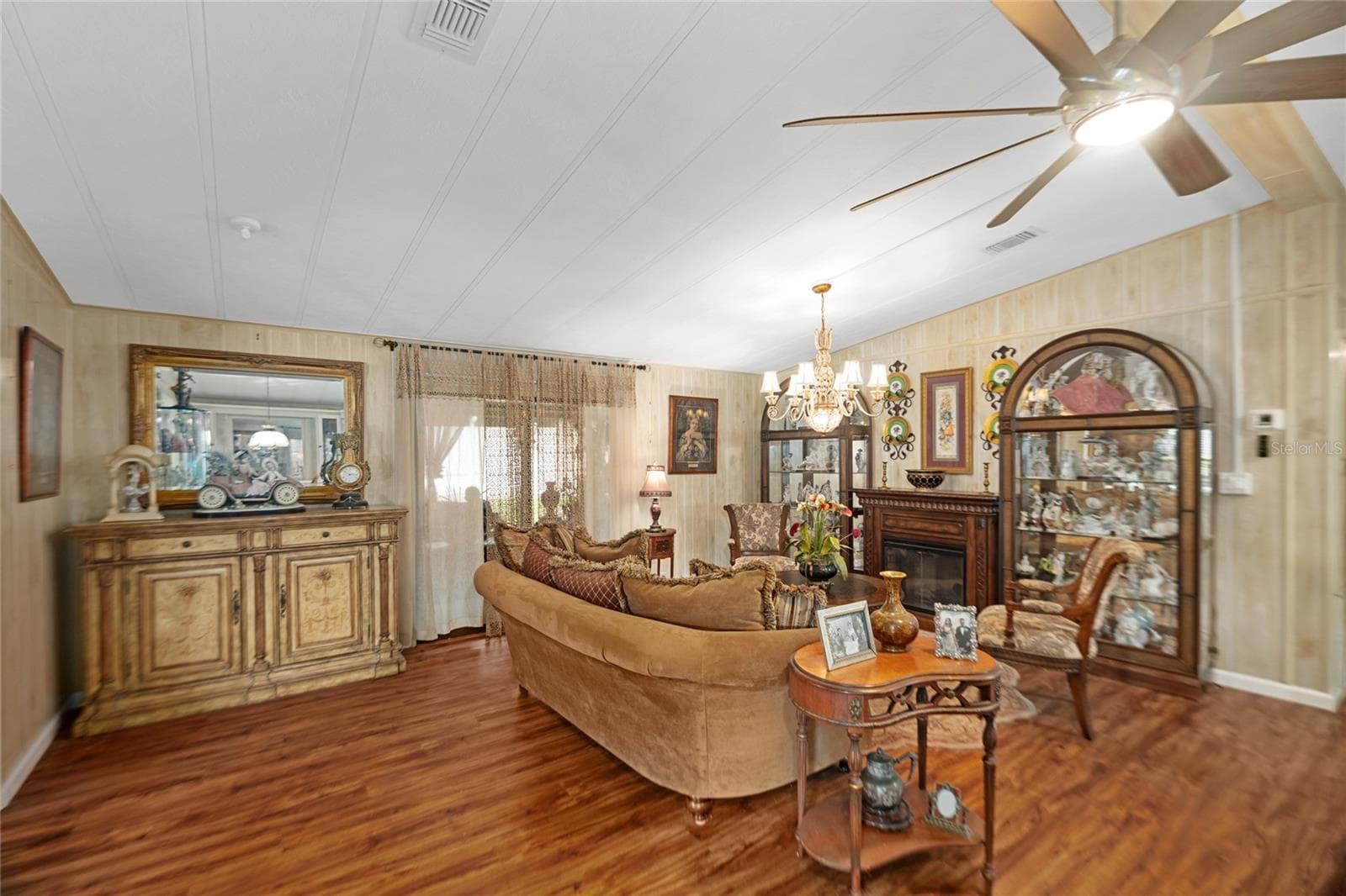 Living room with sliding doors to lanai (view from dining room) - 2002 S CITRUS CIR #1728, ZELLWOOD