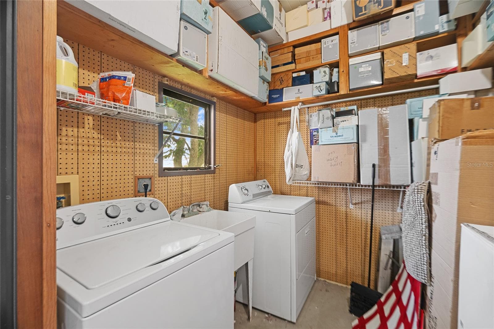 Laundry room with shelving up to the 9' ceilings - 2002 S CITRUS CIR #1728, ZELLWOOD