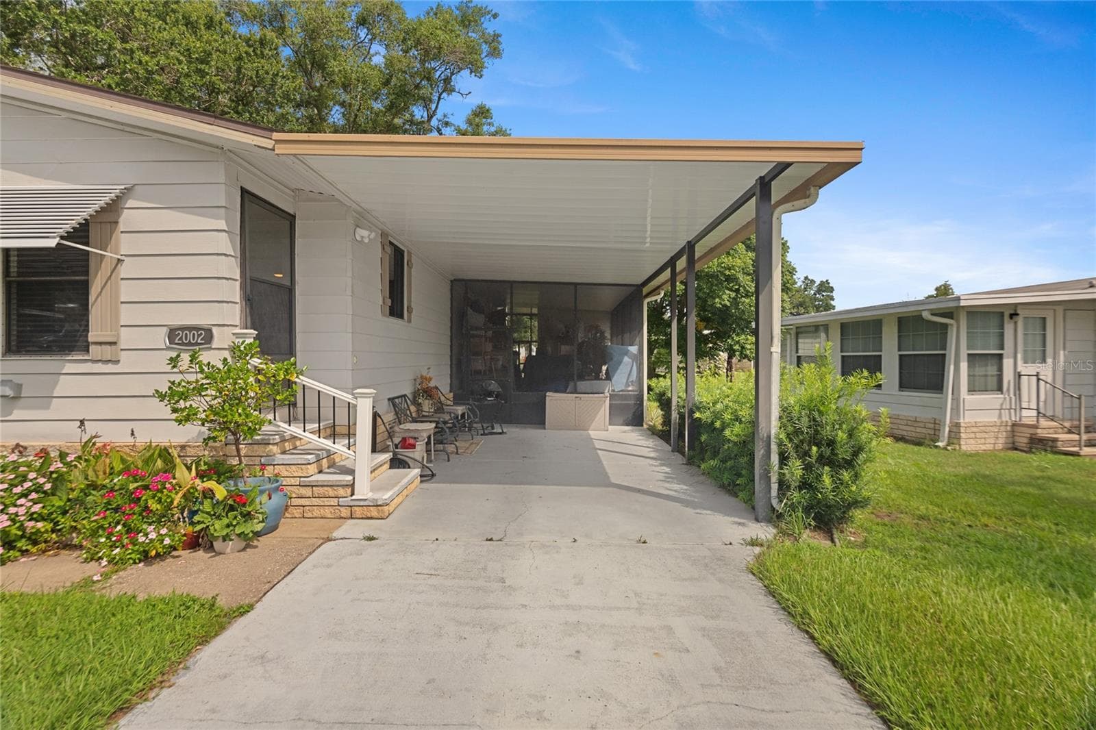 Wide carport, additional screened patio behind - 2002 S CITRUS CIR #1728, ZELLWOOD