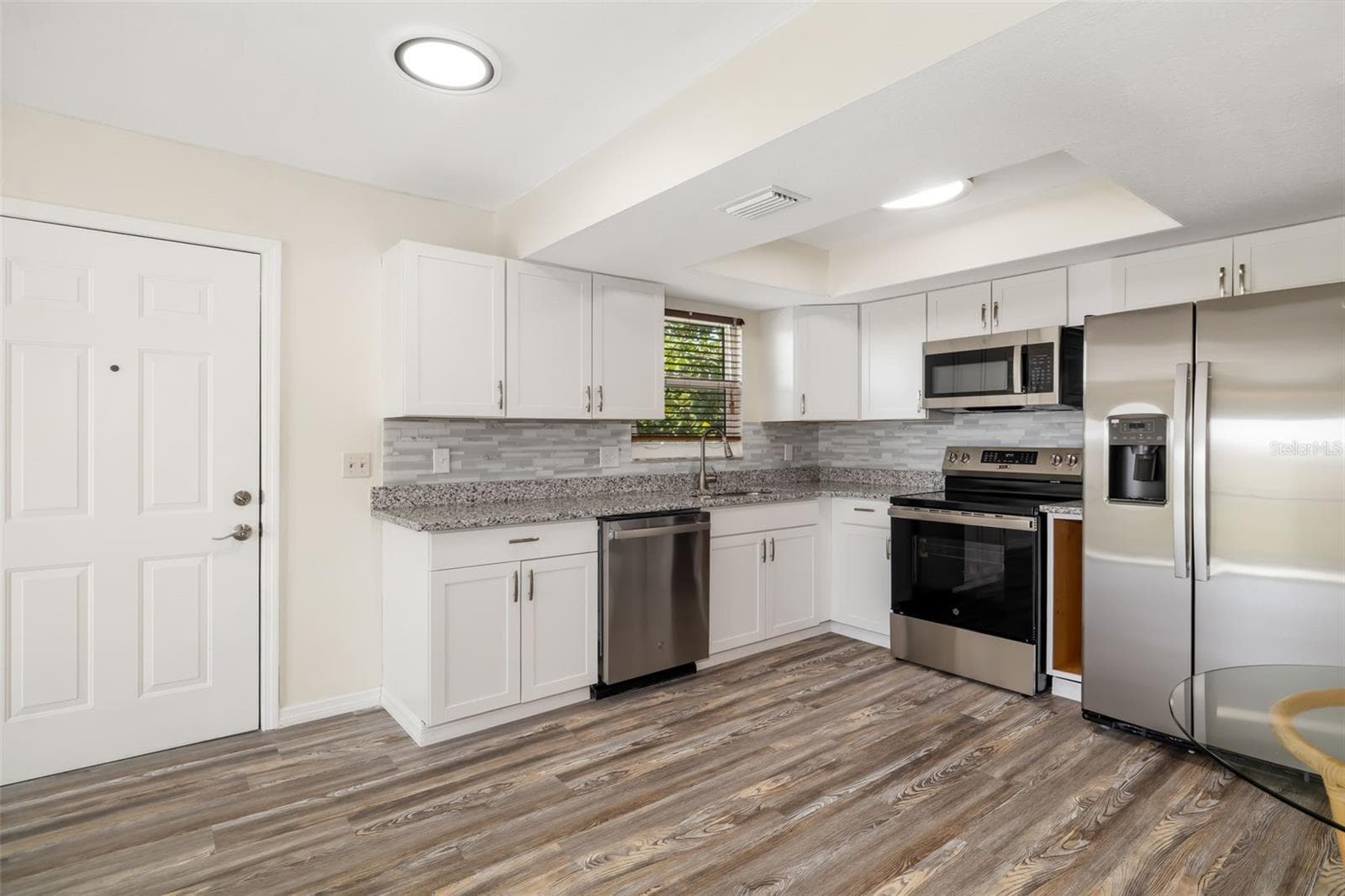 Functional kitchen layout with generous storage and workspace for daily living. - 2513 AVENUE B #B, BRADENTON BEACH