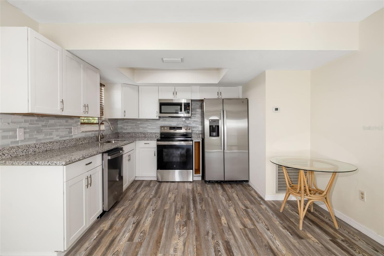 Kitchen – Extended ViewOpen kitchen design with ample counter space and seamless connection to dining and living areas.Open-concept kitchen with ample counter space and functional layout. - 2513 AVENUE B #B, BRADENTON BEACH