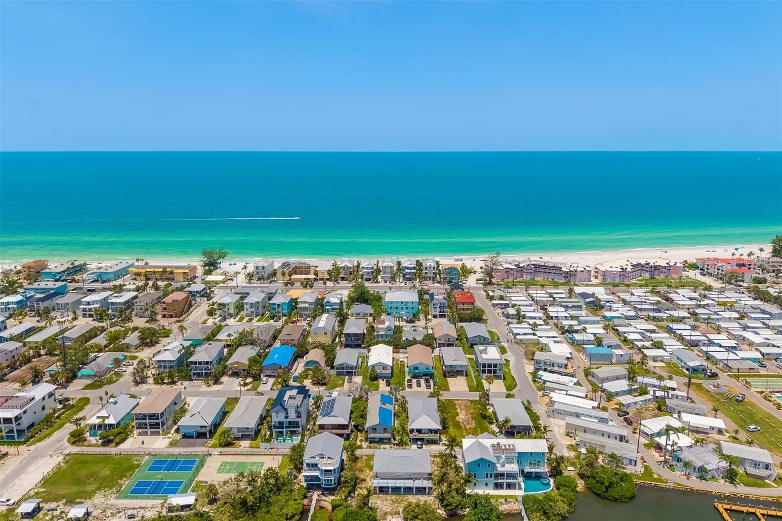 Aerial – Full Island PerspectiveAerial view showcasing the home’s prime location between Sarasota Bay and the Gulf of Mexico. - 2513 AVENUE B #B, BRADENTON BEACH