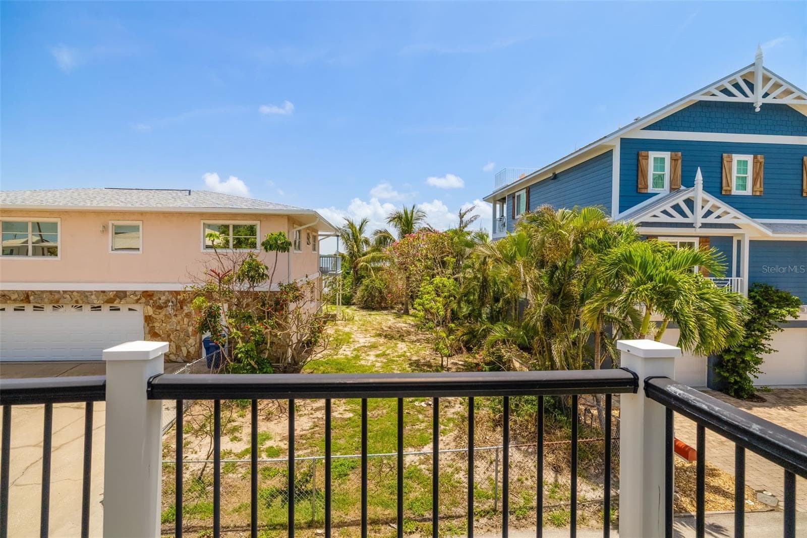 Deck View Toward Lot / Neighboring HomesPrivate deck view overlooking surrounding homes and green space with room to relax outdoors. - 2513 AVENUE B #B, BRADENTON BEACH