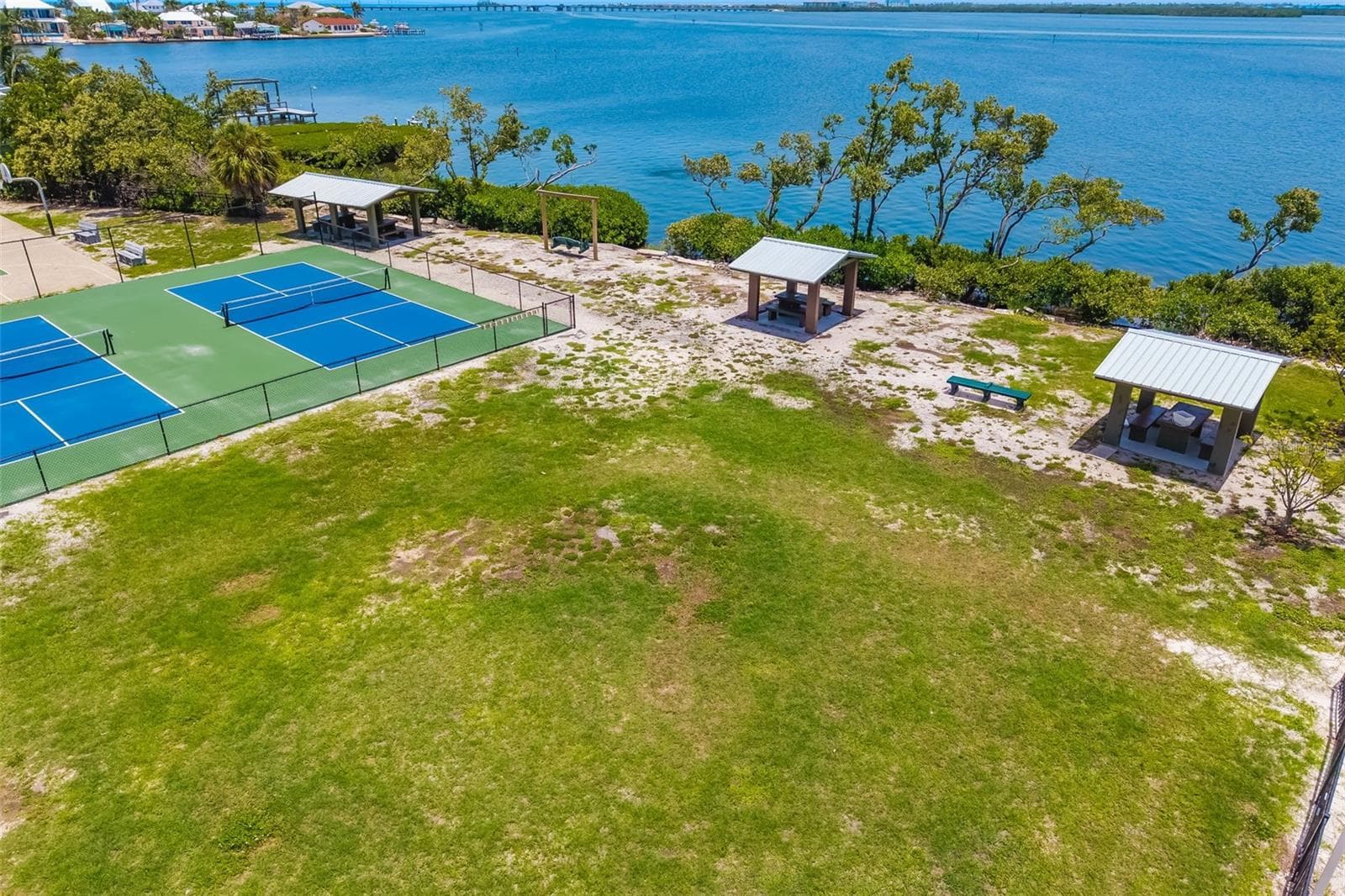 Nearby Park & Tennis CourtsNearby green space with tennis courts and shaded areas for outdoor recreation. - 2513 AVENUE B #B, BRADENTON BEACH