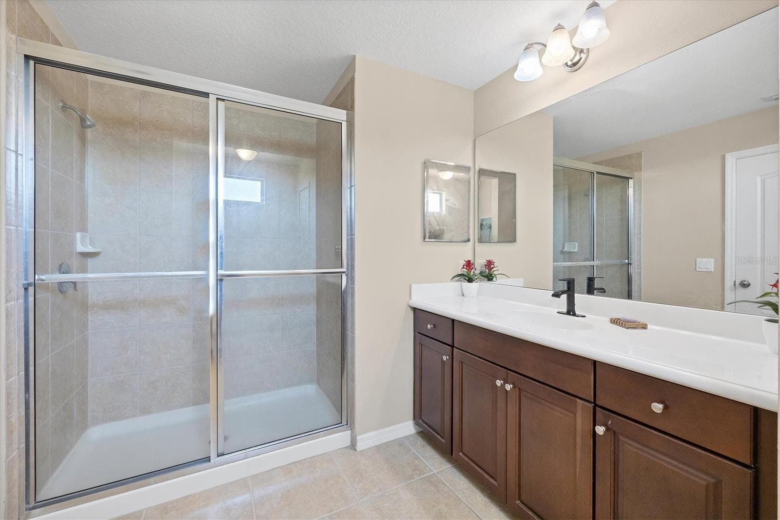 Primary suite bath has walk in shower - 4811 WOODBROOK DR, SARASOTA