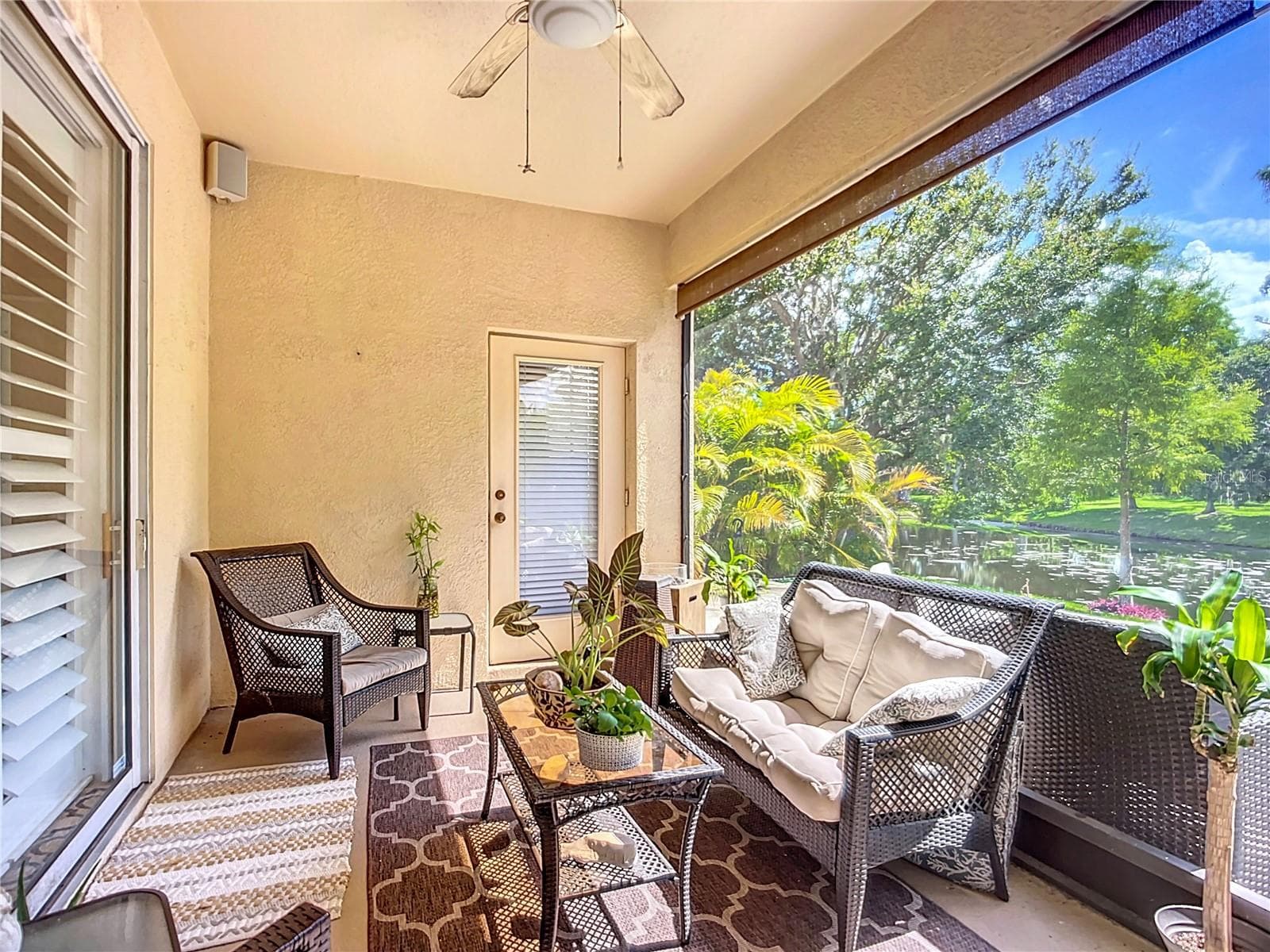 Back patio with a roll-down blind. - 3409 61ST TER E, ELLENTON