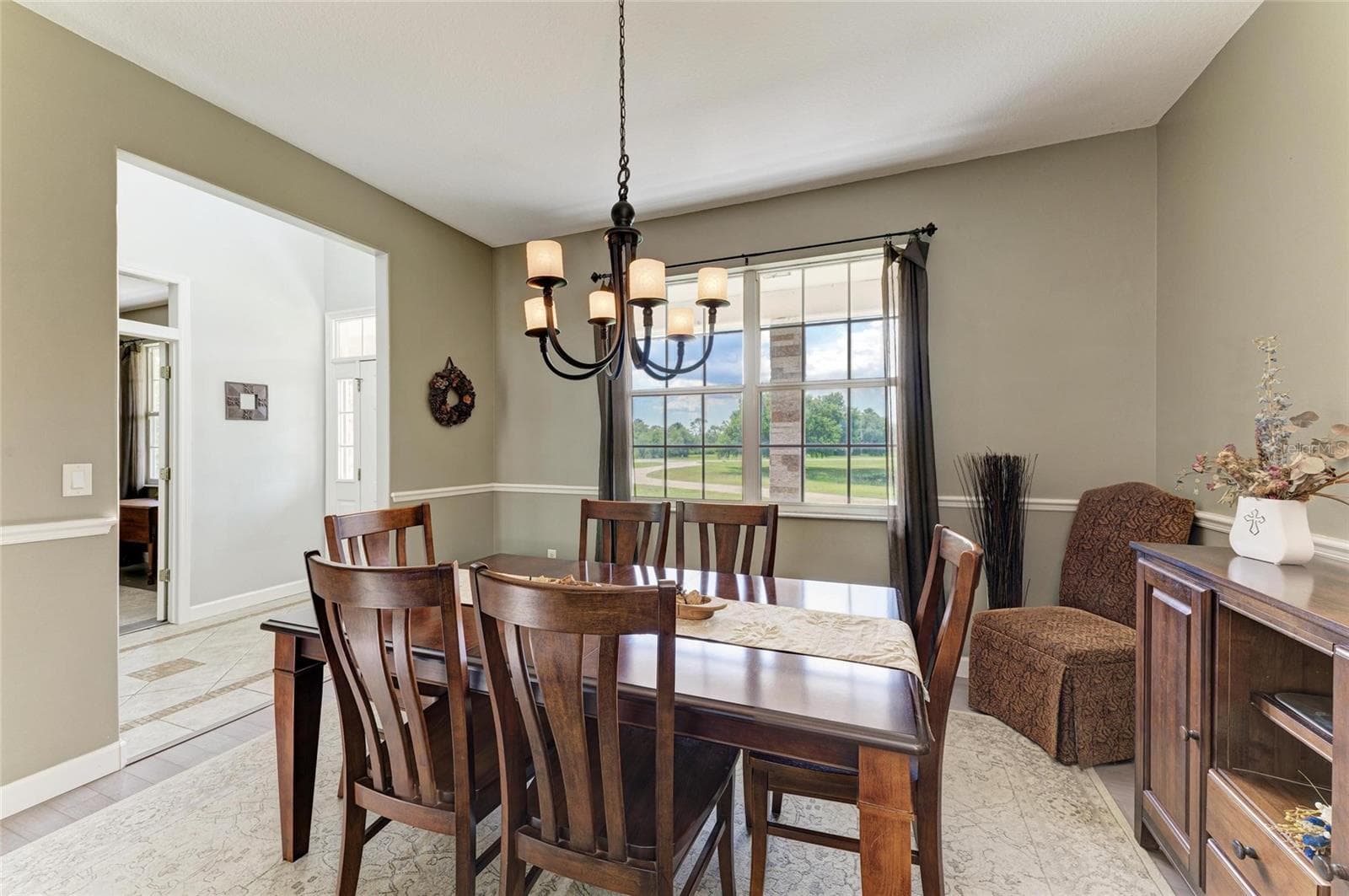 Dining Room off Kitchen and Foyer with Double Window Views of Front Lawn - 8331 241ST ST E, MYAKKA CITY