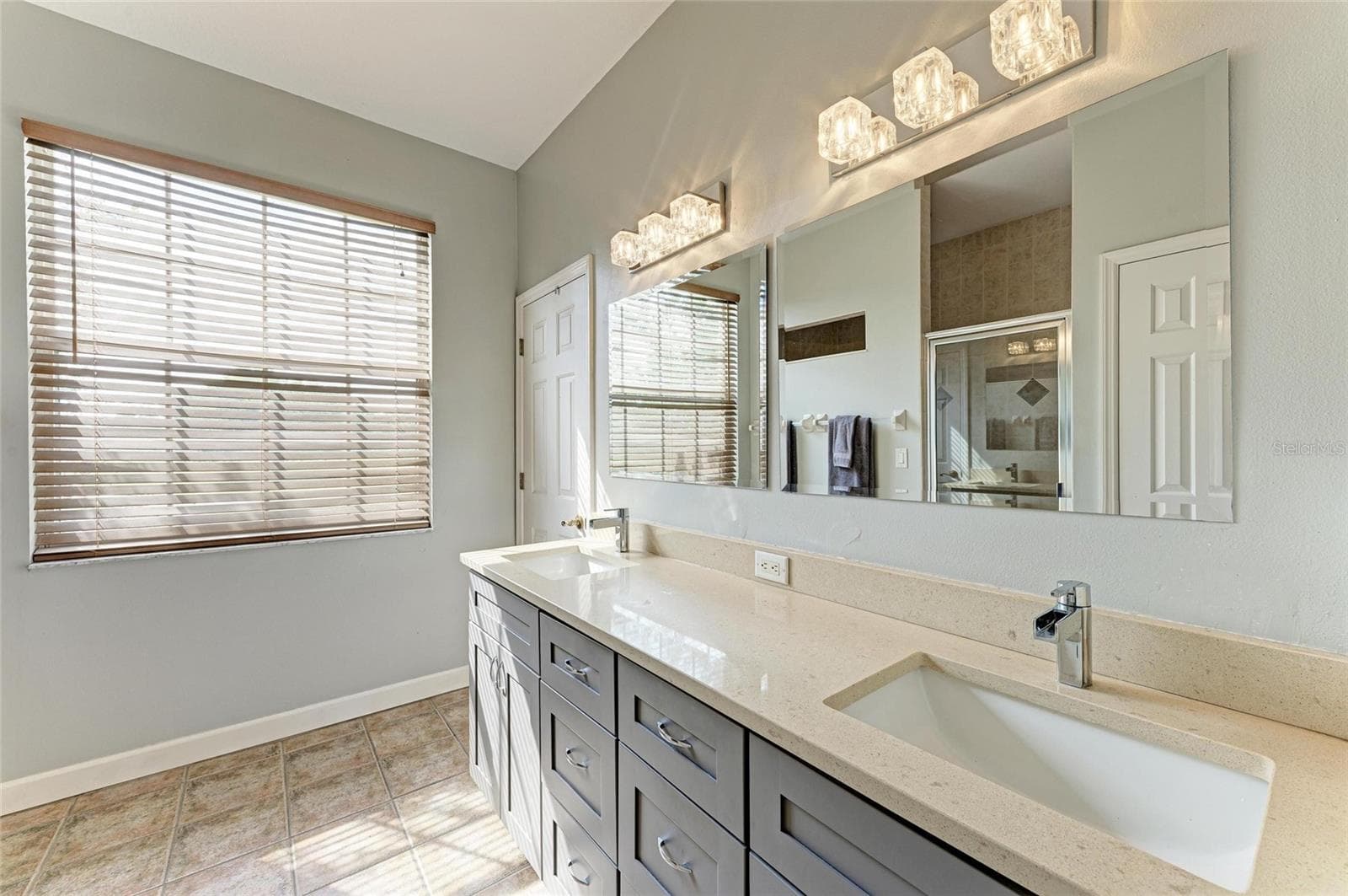 Primary bathroom with stone counters and dual vanity - 8331 241ST ST E, MYAKKA CITY