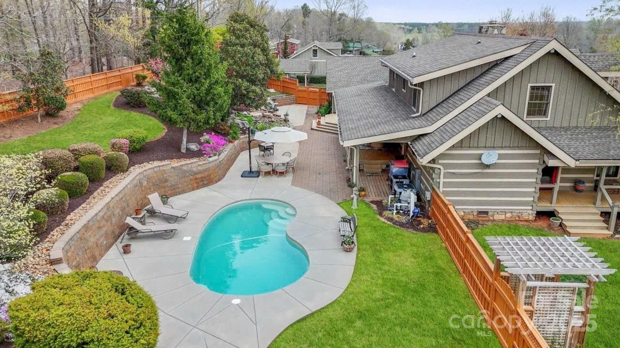Look at all this privacy. Beautifully landscaped, private and fenced. The pool is a salt water in ground pool. - Mooresville