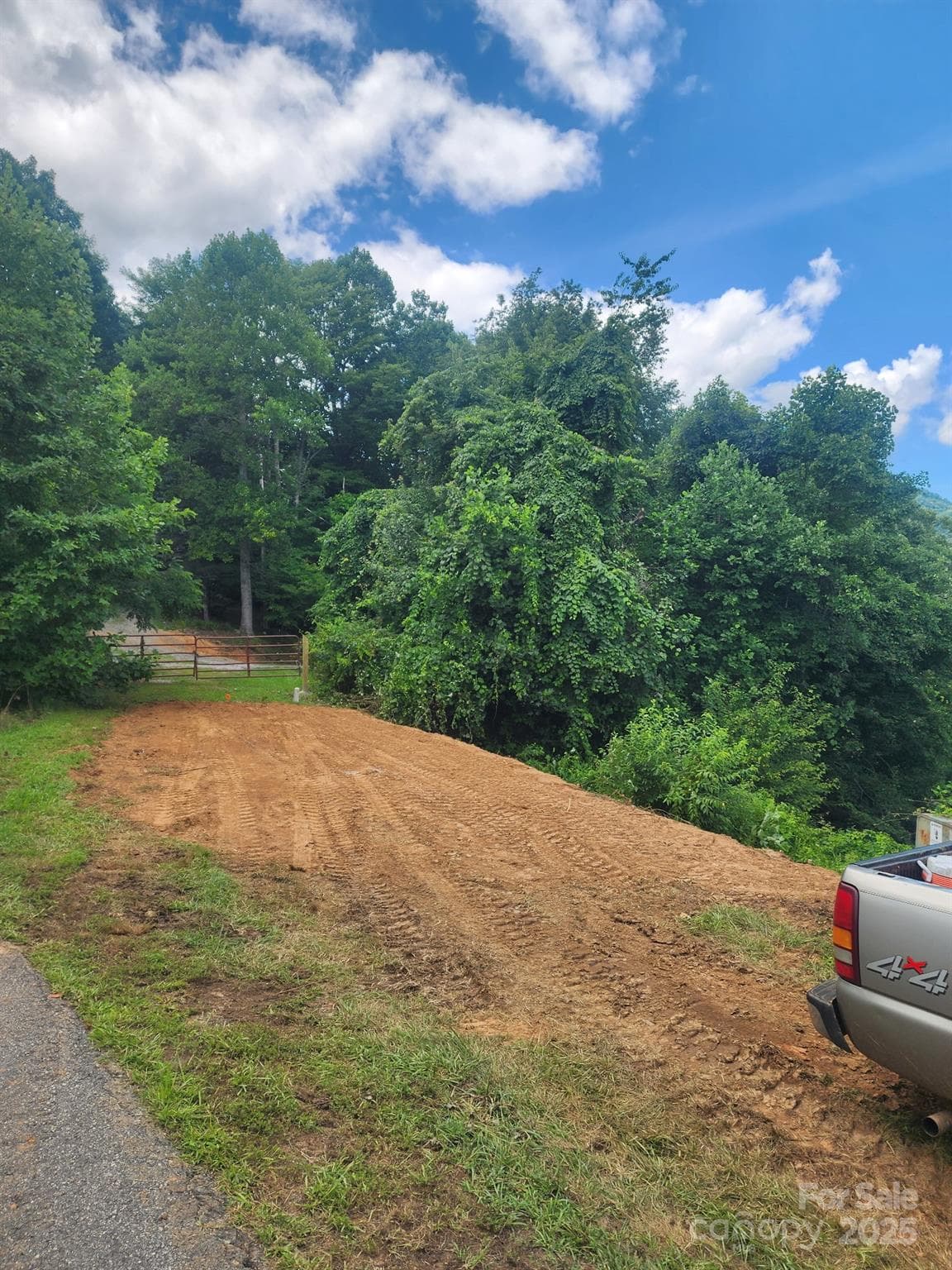 Lot continues past red gate to center of Whispering Wind Rd to above ground elec - Waynesville